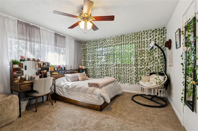 bedroom featuring baseboards, ceiling fan, a textured ceiling, and carpet