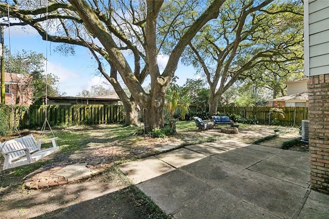 view of yard with a patio, central AC, and a fenced backyard