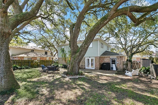 exterior space with french doors, a fenced backyard, and a patio area