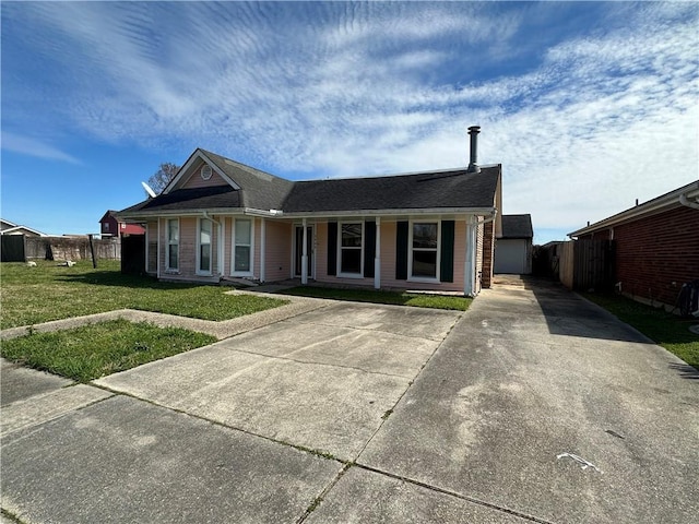 ranch-style home with a front lawn, fence, and a garage