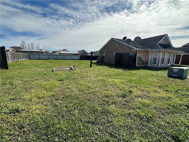 view of yard with cooling unit and a fenced backyard