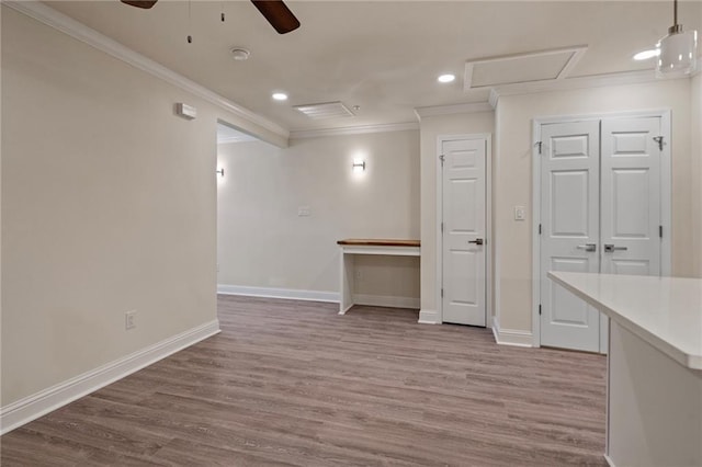 below grade area with recessed lighting, baseboards, wood finished floors, and ornamental molding