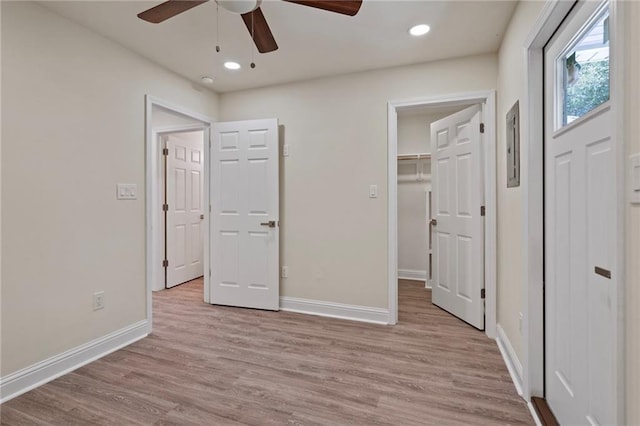 unfurnished bedroom with a spacious closet, baseboards, ceiling fan, light wood-type flooring, and recessed lighting