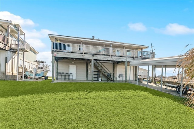 rear view of property featuring stairway, a lawn, and a wooden deck