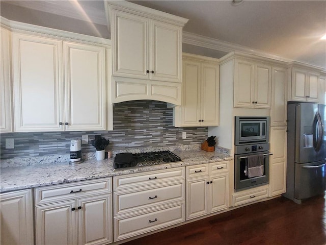 kitchen featuring decorative backsplash, light stone counters, dark wood-style floors, and appliances with stainless steel finishes