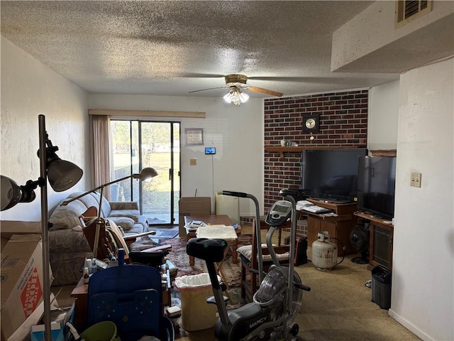 living room featuring visible vents, baseboards, ceiling fan, carpet flooring, and a textured ceiling