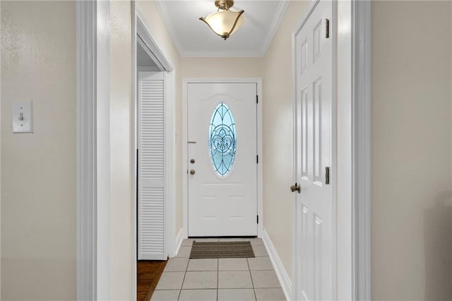 entrance foyer featuring light tile patterned floors, baseboards, and ornamental molding