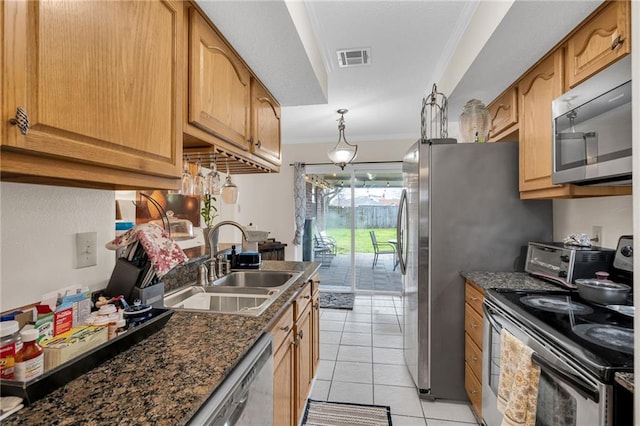 kitchen featuring ornamental molding, a sink, stainless steel appliances, a toaster, and light tile patterned floors