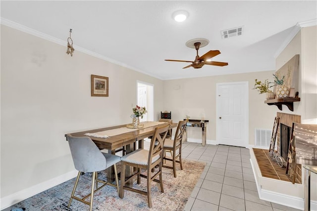 dining area featuring visible vents, baseboards, light tile patterned flooring, and crown molding