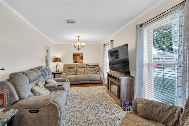 living room with crown molding, wood finished floors, visible vents, and a chandelier