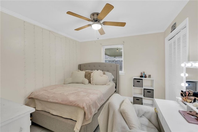 bedroom with a closet, ceiling fan, and ornamental molding