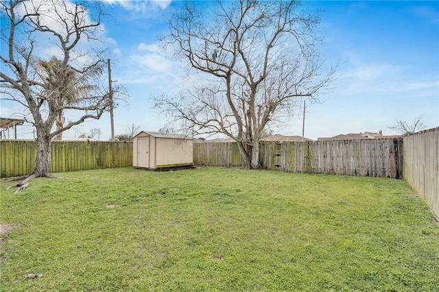 view of yard with a fenced backyard, a storage shed, and an outdoor structure