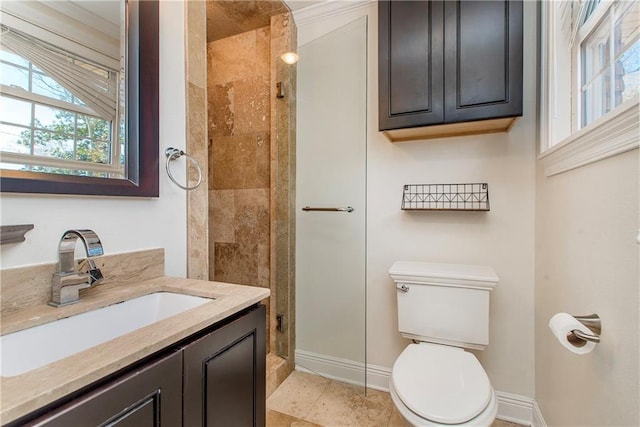 bathroom featuring baseboards, toilet, a stall shower, and vanity