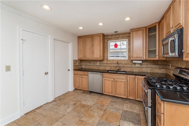 kitchen with recessed lighting, a sink, glass insert cabinets, appliances with stainless steel finishes, and backsplash