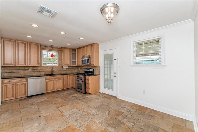 kitchen featuring dark countertops, visible vents, baseboards, appliances with stainless steel finishes, and a sink