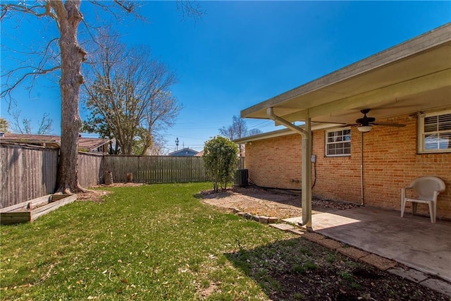 view of yard featuring a fenced backyard, a patio area, central AC, and ceiling fan