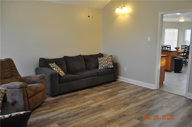 living room featuring baseboards and wood finished floors