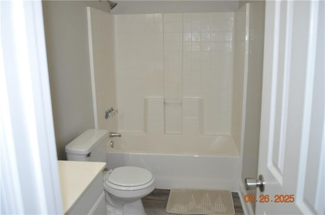 bathroom featuring bathing tub / shower combination, toilet, and vanity