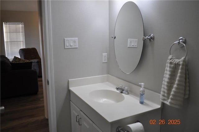 bathroom with wood finished floors and vanity