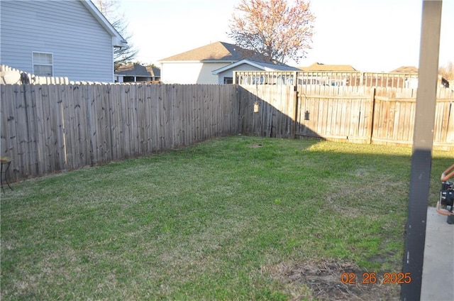 view of yard with a fenced backyard