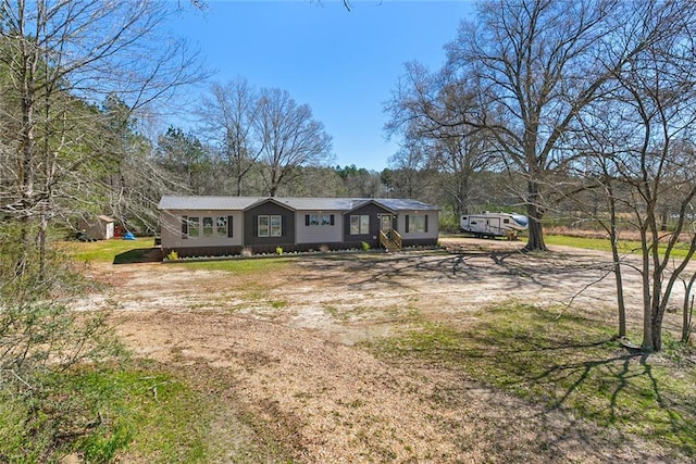 view of front of home featuring dirt driveway