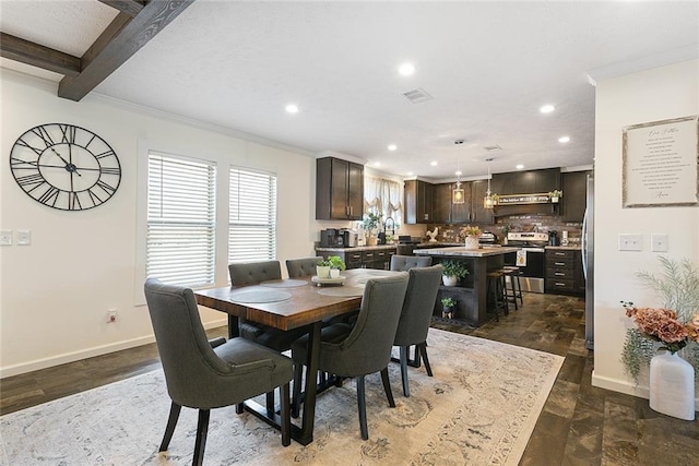 dining space with visible vents, crown molding, and baseboards