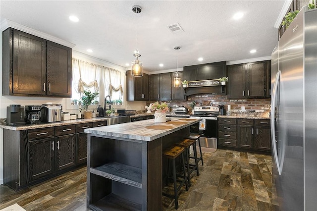 20228 Stafford Rd, Kentwood, LA 70444 - kitchen with appliances with stainless steel finishes, open shelves, a sink, custom exhaust hood, and a breakfast bar