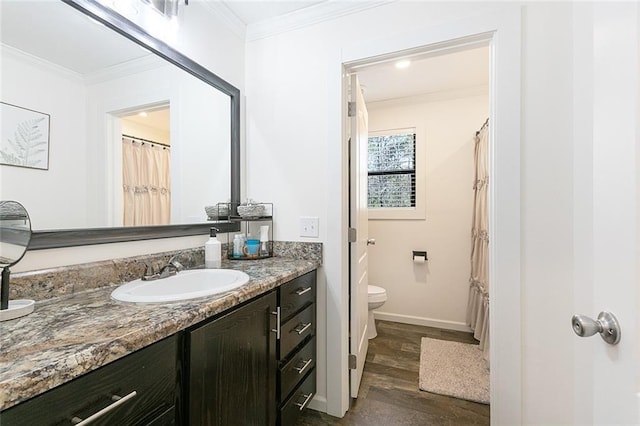 full bathroom featuring vanity, crown molding, toilet, and wood finished floors