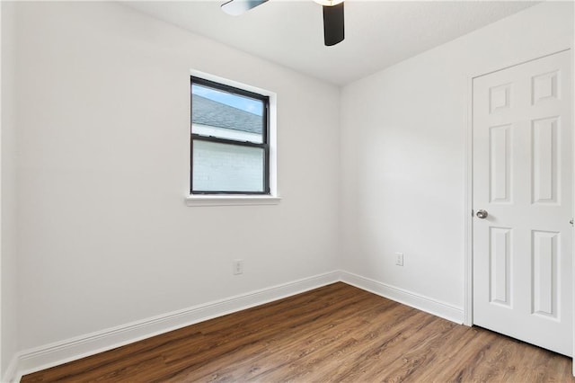 unfurnished room featuring baseboards, wood finished floors, and a ceiling fan