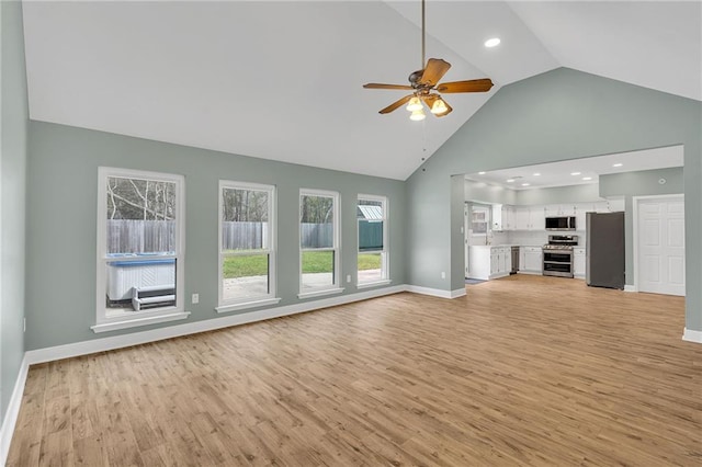 unfurnished living room with high vaulted ceiling, a ceiling fan, recessed lighting, light wood-style floors, and baseboards