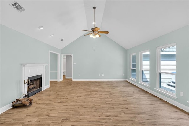 unfurnished living room with light wood-style floors, a fireplace, visible vents, and baseboards