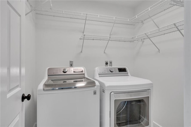 washroom featuring independent washer and dryer and laundry area