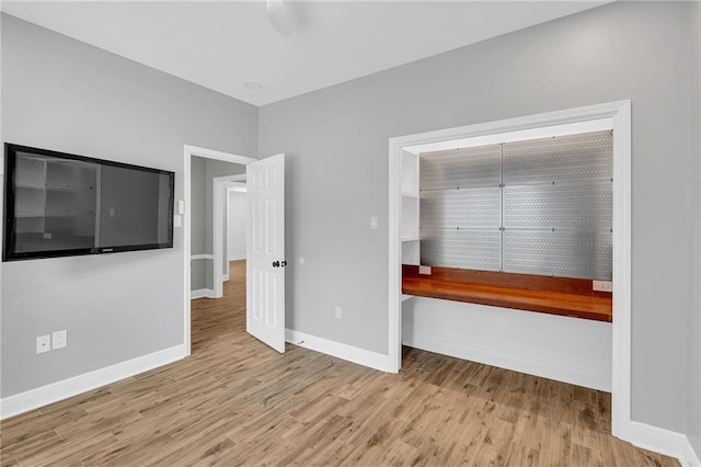 interior space featuring wood finished floors and baseboards