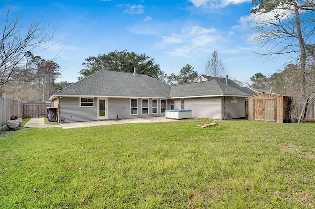 rear view of house featuring a lawn, a patio, a fenced backyard, a shed, and an outdoor structure