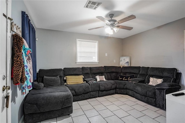 living area featuring a ceiling fan and visible vents