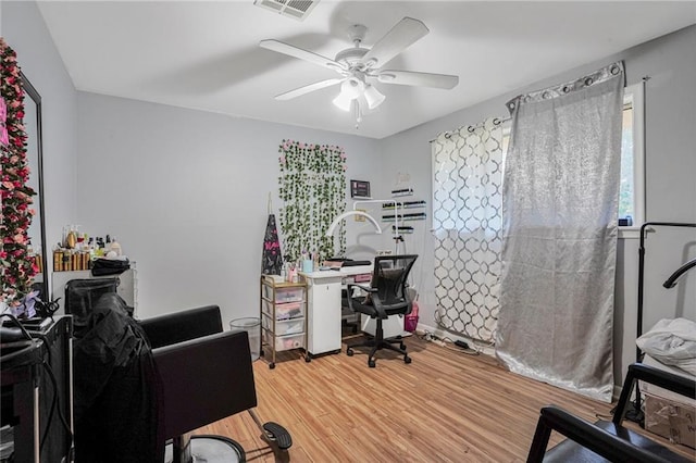 home office featuring visible vents, a ceiling fan, and light wood finished floors