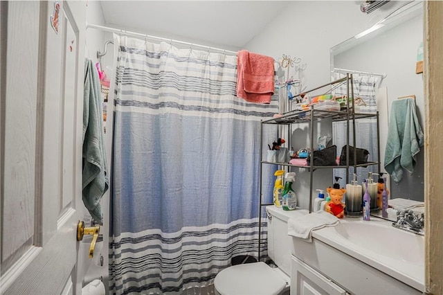 bathroom featuring vanity, a shower with shower curtain, and toilet