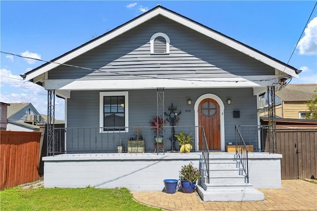 view of front facade with a porch and fence