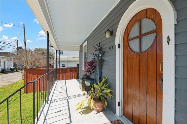 entrance to property with a lawn and covered porch