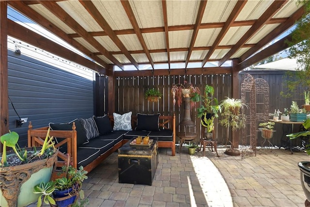 view of patio / terrace featuring an outdoor living space, an outdoor structure, and fence