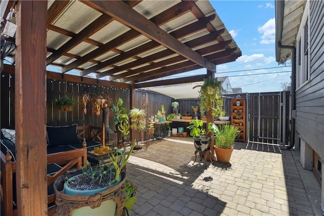 view of patio / terrace with a gate, a pergola, and fence