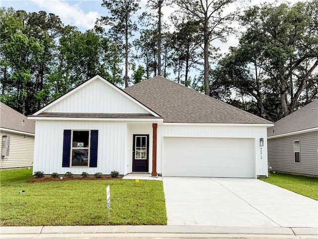 view of front of home with roof with shingles, concrete driveway, a garage, and a front lawn