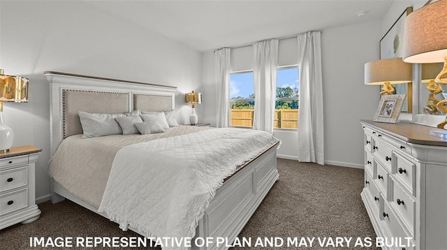 bedroom featuring dark colored carpet and baseboards