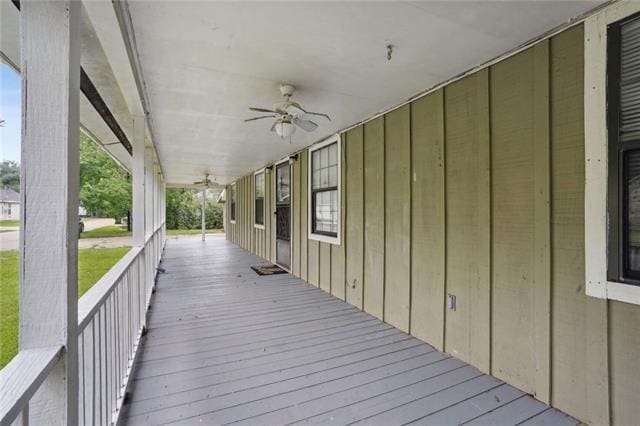 wooden deck with a porch and ceiling fan