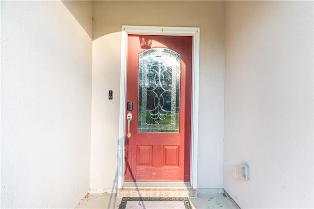 view of exterior entry featuring stucco siding