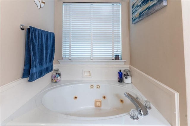 bathroom featuring a tub with jets