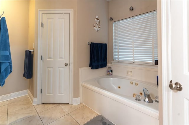 full bath with tile patterned floors, baseboards, and a tub with jets