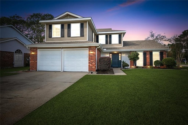 traditional-style house featuring brick siding, an attached garage, concrete driveway, and a front lawn