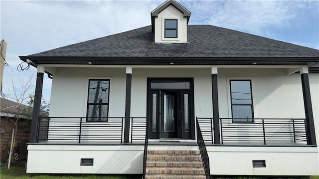 view of front of house with stucco siding, covered porch, roof with shingles, and crawl space