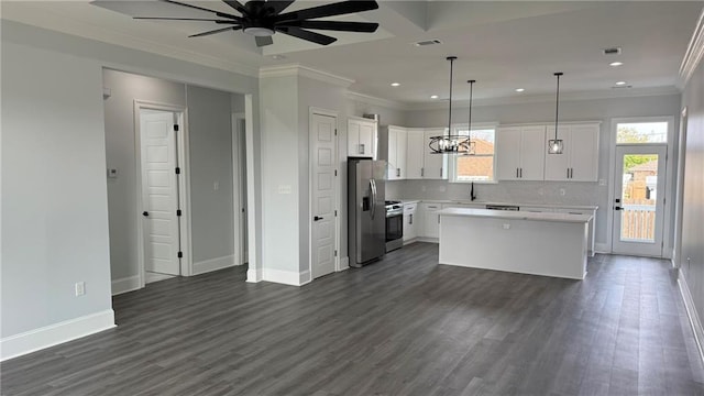 kitchen featuring a kitchen island, a sink, light countertops, appliances with stainless steel finishes, and backsplash